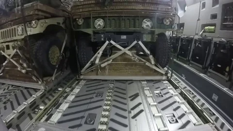 U.S. Airmen execute an air drop of eight military convoy vehicles - 2017 Video stock 92751313