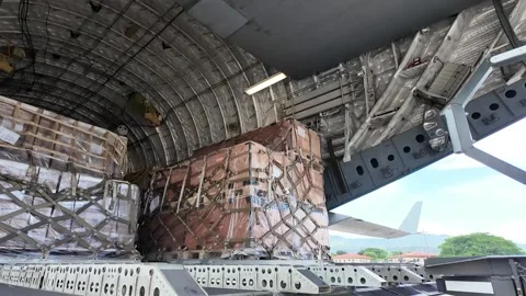 U.S airmen offloading pallet of humanitarian aid from C-17 Globemaster Stock Footage 281932555