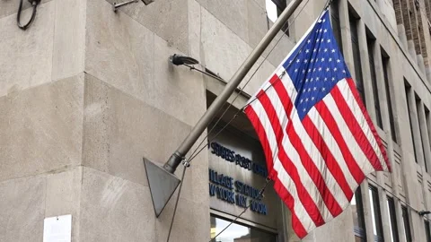 Us american flag waiving in the breeze wind in front of post office Video stock 303592467