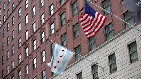 US and Chicago Flag in Slow motion on side of building in Chicago Stock Footage 132463283