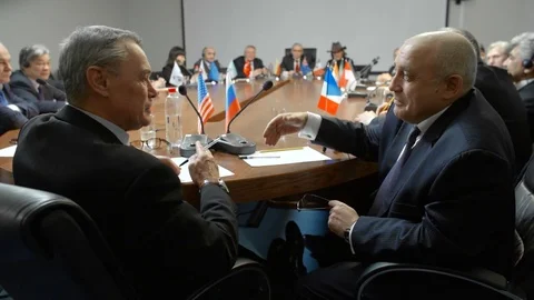 US and Russian delegates or representatives reach an agreement and shake hands Stock Footage