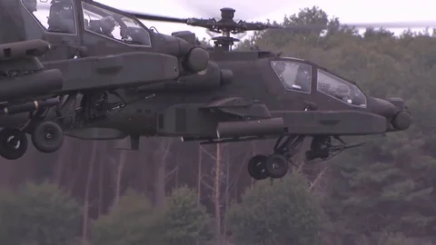 US Apache helicopters perform a maneuver, hover in the air then fly rapidly Stock Footage 120948620