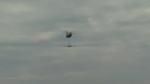 U.S. Army CH-47 Chinook transporting F-80 'Shooting Star' aircraft Stock Footage 211806545