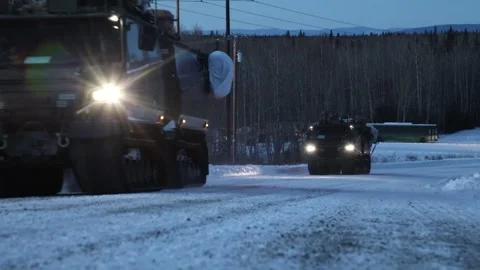 U.S. Army Cold Weather All-Terrain Vehicles (CATV) travelling at dusk Stock Footage 260223083