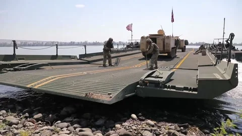 U.S. Army floating bridge setting off from shoreline Stock-Footage 160106800