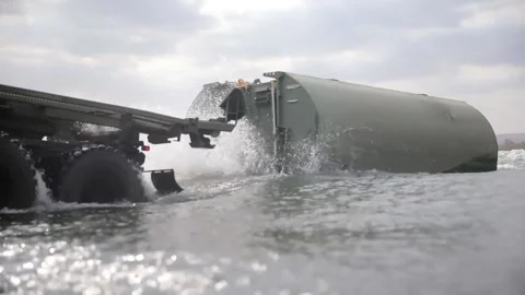 U.S. Army floating bridge slides into water from rear of M1977T CBT Vídeos de archivo 160106780
