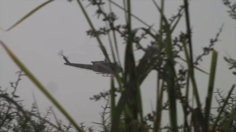 An US army helicopter flying over a field in Afghanistan Stock Footage 86295668