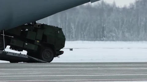 U.S. Army HIMARS being driven off Belgian Air Force Airbus Atlas A400M aircraft Stock Footage 257553116
