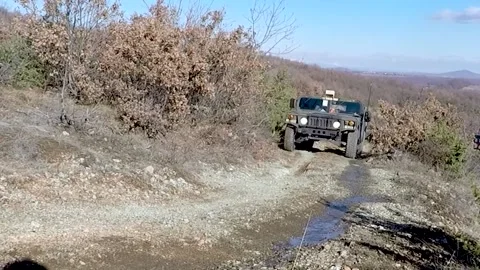 U.S. Army Humvee being driven along mountain track Video stock 168233131
