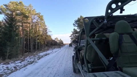 U.S. Army M1301 Infantry Squad Vehicles travelling on snow covered forest road Stock Footage 297953172