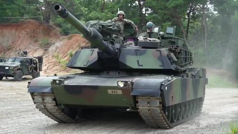 U.S. Army M1A2 Abrams battle tank tracking on dirt road at gunnery Stock Footage 281062646