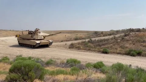 U.S. Army M1A2 Abrams battle tank travelling over sandy track Stock Footage 289282923