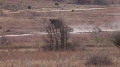 U.S. Army M2A3 Bradley Fighting Vehicle travelling on a dirt road Stock Footage 301062758