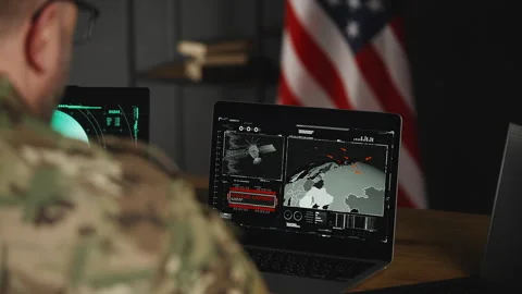 U.S. army officer observing offensive simulation and missile launch on laptops Stock Footage 334669177