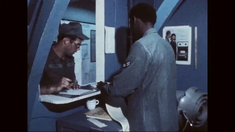 US Army pilot files flight plan at heliport dispatch office - 1977 Stock Footage 97905200