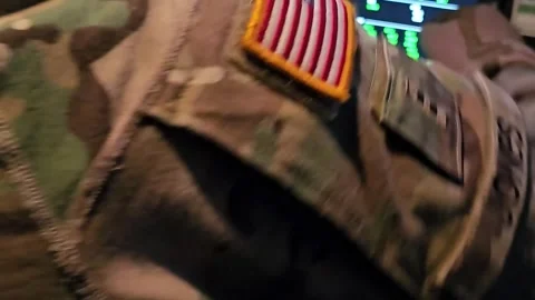U.S. Army pilot referring checklist prior to operating cockpit instruments Stock Footage 289992010