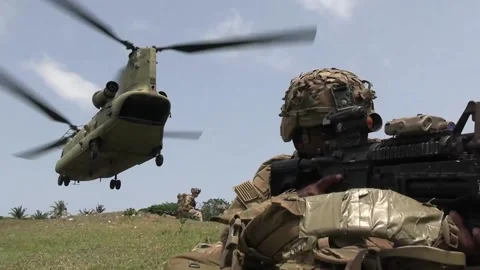 U.S. Army sniper aiming weapon as CH-47 Chinook takes off Video stock 239637910