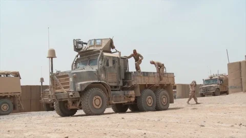 US Army soldier preparing to drive a military truck in Afghanistan Stock Footage 85602230