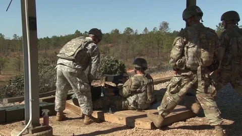 U.S Army soldier sitting down firing machine gun Stock Footage 82936790