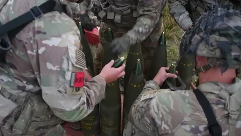 U.S. Army soldiers assembling 155mm projectiles for M777 Howitzer Video stock 254402892