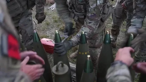 U.S. Army soldiers assembling projectiles for M777 Howitzer Stock Footage 254402893