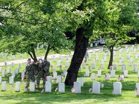 US Army soldiers planting American flags at Arlington cemetary Stock Photos