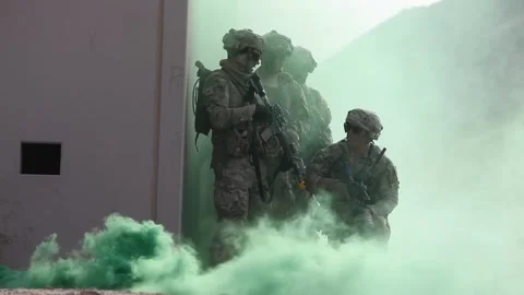 U.S. Army soldiers using smokescreen as cover in urban terrain village Stock Footage 268822857