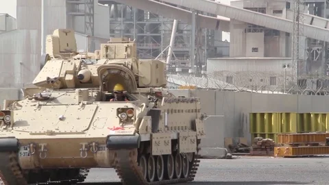 U.S. Army tank tracking along docks for loading onto ship in Kuwait Stock Footage 85838700
