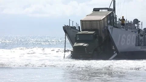 U.S. Army truck being driven off Landing Craft Utility boat into sea Stock Footage 266789043