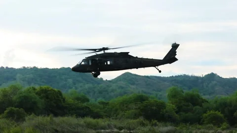 U.S. Army UH-60 Black Hawk taking off from grassland Stock Footage 276830374