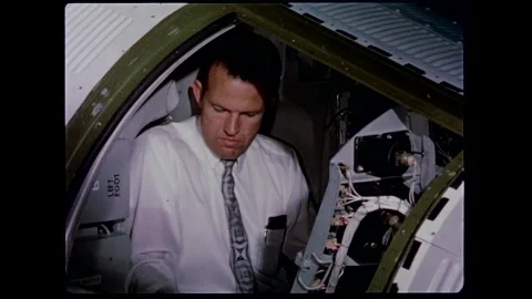 U.S. Astronaut Capt. Gordon Cooper checking out spacecraft controls Stock Footage 263292180