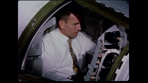 U.S. Astronaut Lt. Comdr. Walter Schirra checking out spacecraft controls Stock Footage 263292192