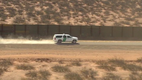 The U.S. Border and Customs Protection patrol the Mexico border with vehicles. Stock Footage 74811160