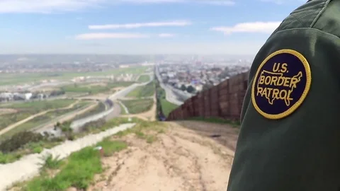 U.S. border patrol officer, jeep near bollard border wall in California - 2017 Stock Footage