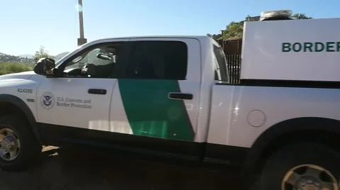 US Border Patrol trucks park near the fence by the Mexican border Stock Footage 62957997