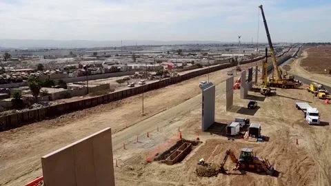 U.S. Border Wall Construction With Small City in the Background Stock Footage 130589215