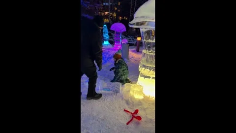 US: Boy accidentally knocks over ice sculpture during snowy outing in Vai... Stock Footage 329599616