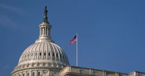 The US Capitol Building Dome Blue Sky with Flag Stock Footage