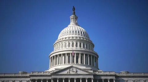 US Capitol Building Dome, MCU, Flag Flowing in the wind, clear blue sky Stock Footage 46943332