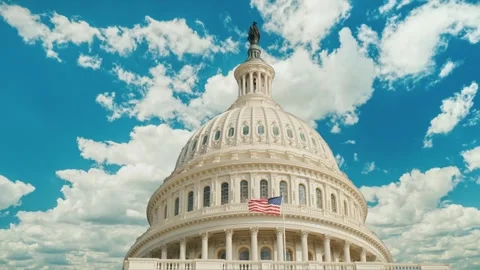 Us capitol building dome in washington dc with clouds moving across blue sky. Stock Footage 334698582