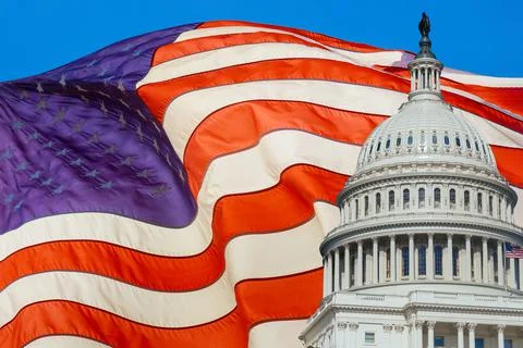US Capitol Building on flag of United States of America waving in the wind. Stock Photos