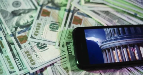 U.s. Capitol Image on iphone surrounded by $100 Bills. Stock Footage 169007204