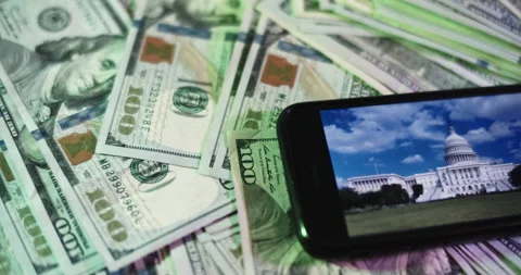 U.S. Capitol Image on iphone surrounded by $100 Bills. Stock Footage 169007430