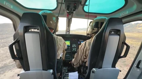 U.S CBP pilot flying AS350 A-Star over desert at low-altitude Stock Footage 301077794