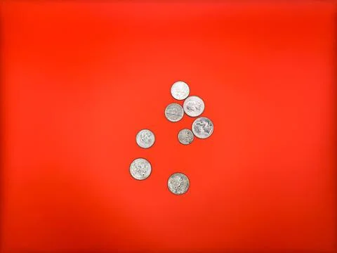 US cents lying next to each other on a bright red background Stock Photos