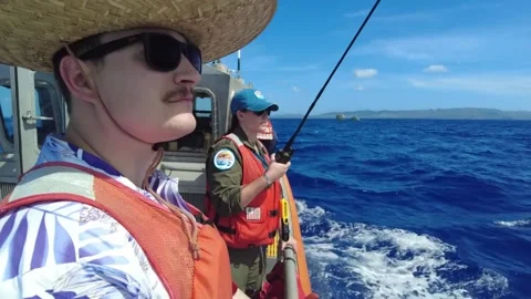 U.S. Coast Guard approaching packages dropped into ocean by boat Stock Footage 295033963