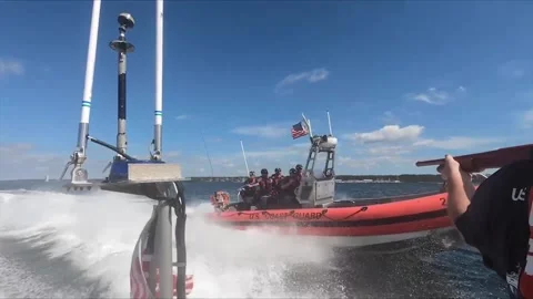 U.S. Coast Guard crew aim weapons from speedboat during pursuit training Stock-Footage 213580231