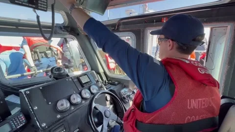 U.S. Coast Guard pilot speaking into fixed VHF radio Stock-Footage 234407456