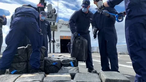 U.S. Coast Guard stack and label bales of seized cocaine aboard Cutter Bertholf Stock Footage 120074511