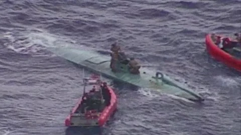 U.S Coast Guard standing aboard semi-submersible smuggling vessel Stock Footage 257666658